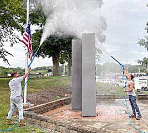 Nicholas Dunn and Joe Kennedy power washing Chester's Kiwanis 911 Remembrance Memorial on Aug. 12.
