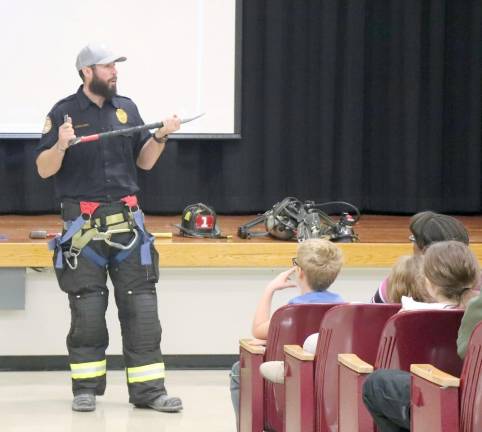 Firefighter Brian Gallo takes a question during a fire safety and prevention assembly at Goshen Intermediate School.