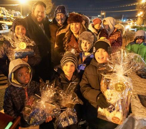 Participants at Chabad Of Orange County’s Chanukah Firetruck Gelt Drop celebrate that they are the “Golden Gelt Winners.” Among the thousands of silver chocolate coins, eight golden chocolate coins were mixed in. Each golden coin was redeemed for a Chanukah gift.