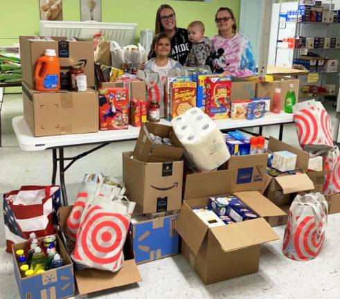 Pictured at the food pantry at the First Presbyterian Church in Chester are Amie Heidecke, her son Logan Heidecke, her daughter Avery Gladden and her mother Linda Heidecke. Provided photos.