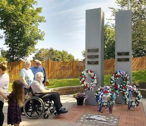 Pat and Chick Morris, the parents of Lynne Morris, reflect on the 9-11 memorial in Chester where their daughter's name is inscribed. Photos by Ginny Privitar.