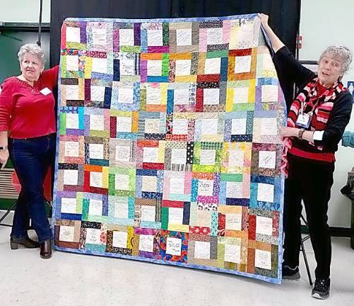 Warwick Valley Quilters' Guild celebrates at annual luncheon President Mary Kirchoff (right) was gifted a signature quilt from the members as thanks for her service. She is pictured with Janet Miller.