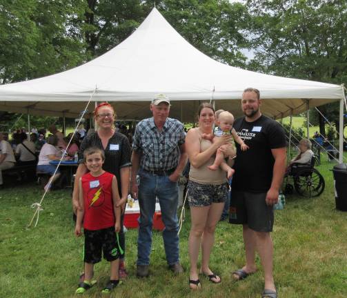 A great day for the Bull family Aiden Johnson, front, and Laura Nywening, Gary Johnson, daughter-in-law Heather, grandson Evan, youngest boy and Evan’s dad, Curtis. (Photo by Ginny Privitar)