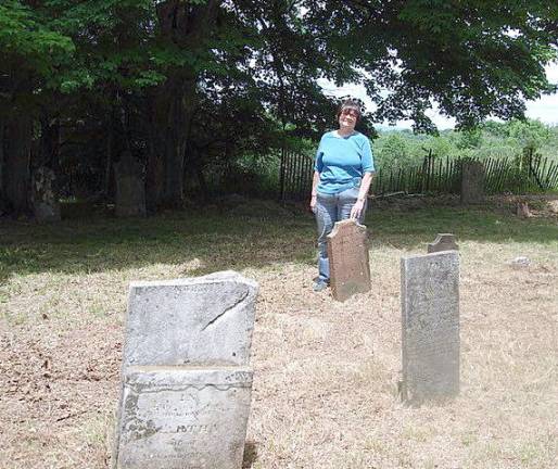 Goshen resident Sandra M. Rothenberger is pleased with the outcome of the cleanup work that Village of Goshen Historian Edward Connor did at the Case Family Burial Grounds on Sarah Wells Trail.