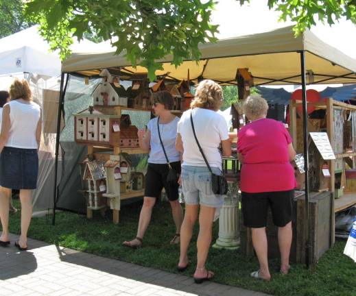 Scenes from Great American Weekend Customers stop to admire Goshen resident Marc Tolen's birdhouses.