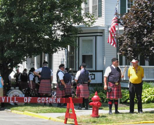 Scenes from Great American Weekend Pipers wait in the shade before performing.