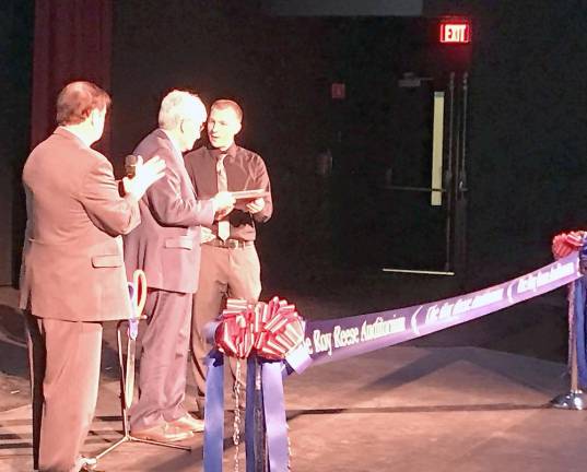 Goshen School District Superintendent Dan Connor ( left) and GHS Technology teacher Joseph Fedor present Roy Reese with a plaque commemorating the dedication.