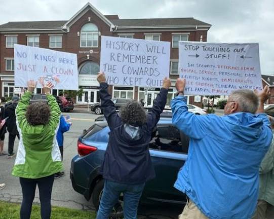 Hundreds rally in ‘No Kings Day’ protest No Kings Day protesters hold signs during the rally in Goshen on June 14, 2025.