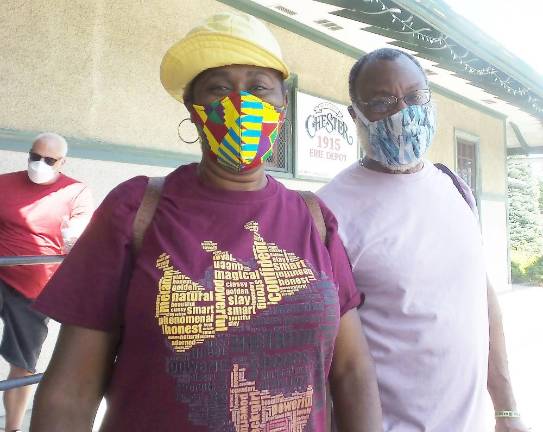 Darlene Hoffman and Curtis Watkins came to listen, learn and march, all in 90+ degree weather.