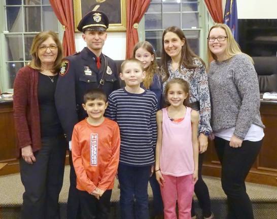 Investigator Michael Gregorio, a champion of vulnerable children, retires from village police department Michael Gregorio and his proud family