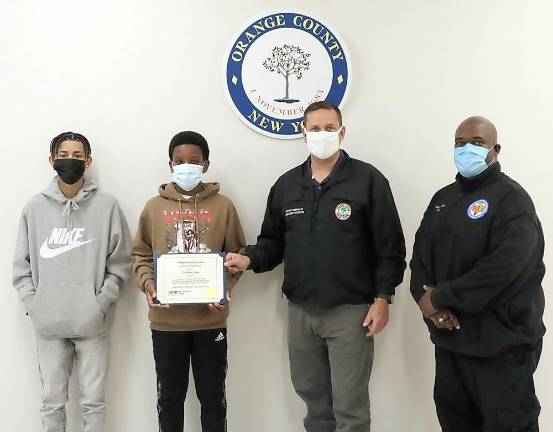 Pictured from left to right are Jayden Mercado, Ty’Shawn James, Orange County Executive Steven M. Neuhaus and Orange County 911 dispatcher Stewart Matthew. Photo provided by Orange County.