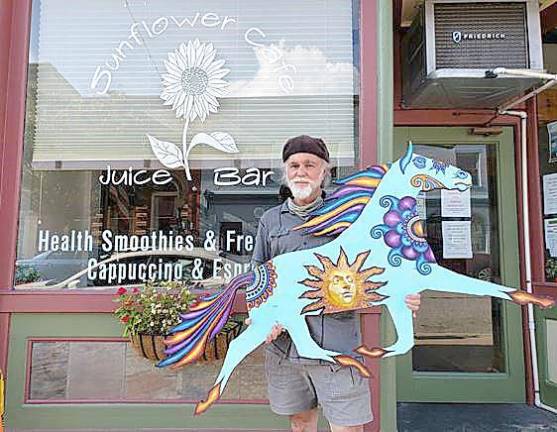 Keith Roddey with his Corona Trotter outside of The SunFlower Cafe.