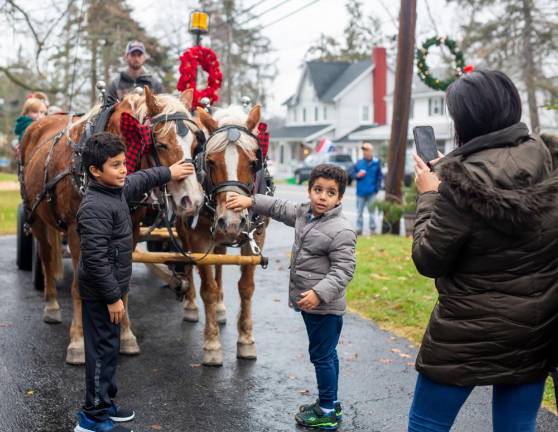 Johnathan and Jacob Khalifa pet the horses after their ride across town.