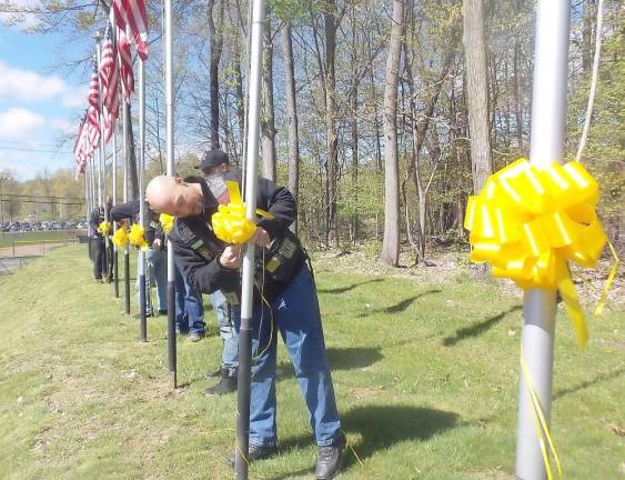 Nam Knights assisted in placing the yellow ribbons on the flag poles.