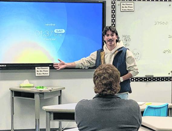 Andrew Rampulla speaks to Goshen High School students about how he managines his own business.