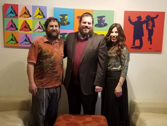 Chabad hosts Jewish pop art event Photos Courtesy of Rabbi Pesach and Chana Burston "Pop Art Rabbi" Yitzchok Moully, pictured with Chabad Rabbi Pesach and Chana Burston in front of Moully's pop art hanging in Chabad's lobby, led a Jewish Pop Art event at Chabad.