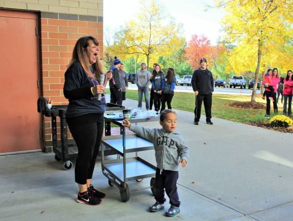 Friends' devotion to Alyssa Barberi transcends time Little Gabriel Burgos reaches for the medal won by Gabriel Thomas as Sue Barberi and everyone else erupts in laughter (Photo by Ginny Privitar)