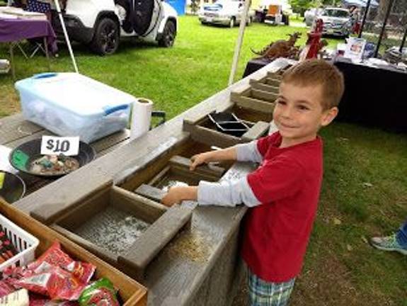 Gold fever strikes Museum Village Carmelo Sosler, 5, had a great time sifting for fossils (Photo by Ginny Privitar)