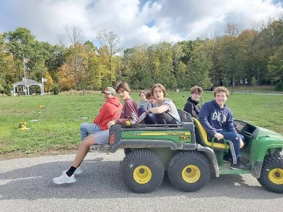 Daniel Hartley and volunteers from Troop 63, Goshen, NY, posed for a picture at Orange County Veterans Memorial Cemetery, where they worked on Dan’s Eagle Project: restoration of information boards, sanding and staining of benches, and raking throughout the cemetery. Pictured are Daniel Hartley (far right) and volunteers from Troop 63 : Aiden Meyers, Joe Carmona, Nick Santoro, Brian Loftus, Tyler Kropp, and Mr. Tom Loftus), Goshen, NY pose for a picture at Orange County Veterans Memorial Cemetery.