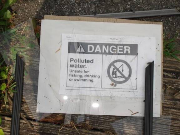 A danger sign by the creek at Myron Urbanski Memorial Park in Goshen.
