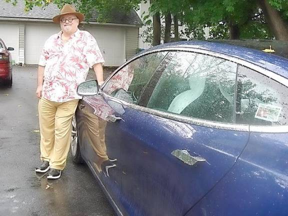 Environmentalist Michael Edelstein with his all electric car, the Tesla Model S.