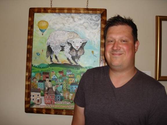 Artists reflect on the meaning of home "The dangers we may not see": Robb Gomulka with his unusual painting (Photo by Geri Corey)
