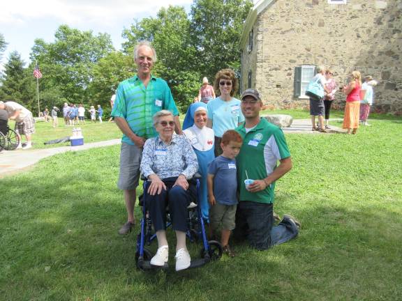A great day for the Bull family Mel Frederick Condit (left), Mary Anne Condit (right), her children, Sister Theresa and Luke Condit, Luke’s son, James, and great-grandmother Mary Emma Condit, seated (Photo by Ginny Privitar)