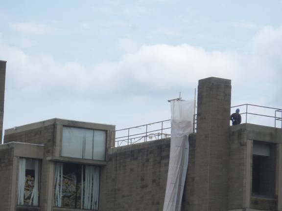 Construction workers were busy on the roof of the Orange County Government Center in Goshen on Thursday as demolition work continues. (Photo by Nathan Mayberg)