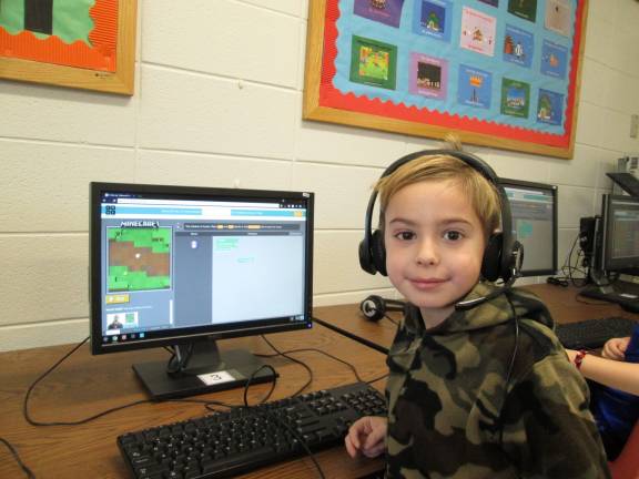 Coding is 'like playing,' young programers say Owen Bayley enjoys coding for the Minecraft game (Photo by Ginny Privitar)
