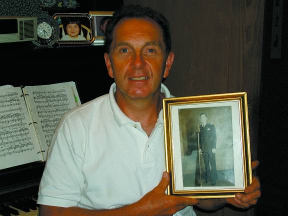 'All kinds of musical things' Gargiulo holds a photograph of his father, Joe, as a young singer (Photo by Geri Corey)
