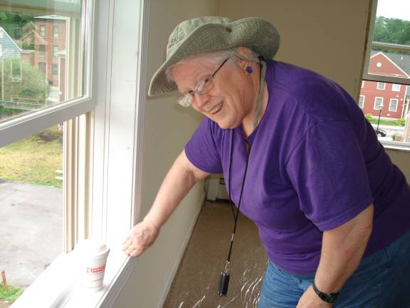 Creating safe places, one house at a time Ann Wood of Goshen takes time to smile for the camera -- but she went right back to work and accomplished much during her time in the Newburgh home. (Photo by Geri Corey)