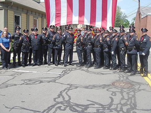 Sgt. Manna exits Goshen PD with walkout ceremony Village of Goshen Chief of Police James Watt, center, with Sgt. John Manna on his left, and the entire Village Police Department on the day of Manna’s retirement.