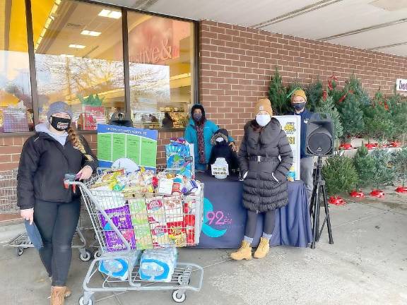 Pictured from left to right are: Felicia Kirshner, iHeartMedia Promotions Director, Dominique Mills, Catholic Charities Ulster County Regional Supervisor, Annie, from “Annie in the Morning with Ryan on Q92,” and Walter Gaceta, Catholic Charities CYO Coordinator, helped collect 10,500 pounds of food donations as part of iHeartMedia’s 23rd annual Friendly Auto Group Stuff-the-Bus food drive to benefit Catholic Charities at area Stop &amp; Shop locations. Provided photo.