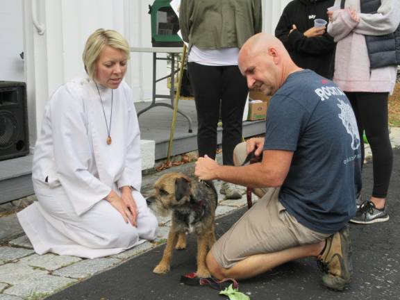 A blessing for Princess Buttercup, and other bright creatures Pastor Susan Chupungco with Willy, a border terrier, and owner, Rick Byrd (Photo by Ginny Privitar)