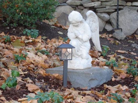 Historic AUMP church survives as 'a beacon of faith' A prayful angelic statue in the medication garden behind the A.U.M.P. Church on Main Street in Goshen (Photo by Geri Corey)