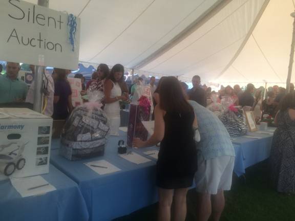 'Eva-ning of Hope' raises $170,000 for research The silent auction of donated gifts
