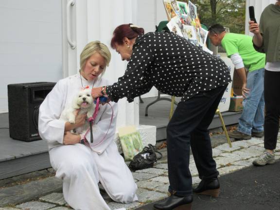 A blessing for Princess Buttercup, and other bright creatures Pastor Chupungco with Looney Tunes, a white Maltese (Photo by Ginny Privitar)