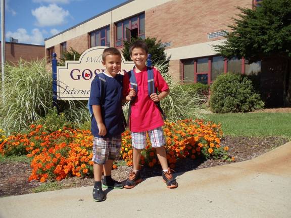 Operation Backpack keeps students well supplied Youth Ending Hunger Club members Michael and Daniel DeRosa are excited to deliver backpacks that they helped to pack.