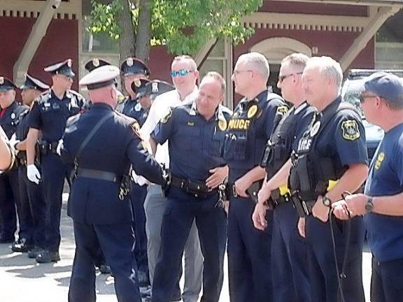 Sgt. Manna exits Goshen PD with walkout ceremony Sgt. John Manna gets a handshake from Allen Faust, a Sergeant with the Town of Goshen Police Department.
