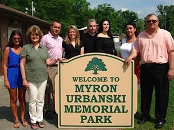 Park renamed for Myron Urbanski Myron Urbanski’s family gather around the new sign renaming the Craigville Park the “Myron Urbanski Memorial Park.” From left: Deanna Torrisi Petruska, granddaughter; Carol Torrisi, daughter; James Bodisch, granddaughter’s husband; Ashley Torrisi Bodisch. granddaughter; Matt DeBlasio, granddaughter’s husband; Diana Urbanski DeBlasio, granddaughter; Barbara Urbanski, daughter-in-law; and Andrew Urbanski, son. Unable to be in the photo was Eric Petruska. “My father would be very proud to know the park is named after him,” said Urbanski’s daughter Carol. Said his son Andrew: “The park is a wonderful thing. As we grew up, there were changes made. I’m happy to see that they’re moving forward with upgrading the park.” (Photo by Geri Corey)