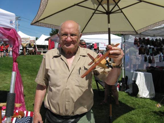 Scenes from Great American Weekend Bill Michalski of Wallkill holds a sample of his woodwork.