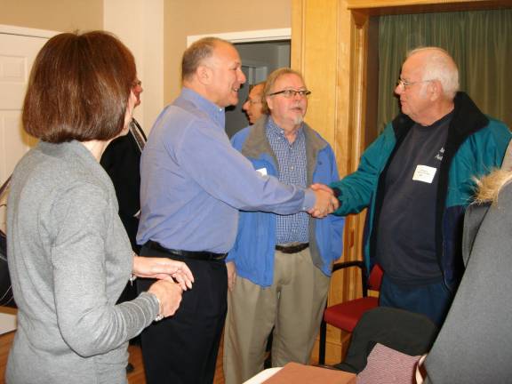 Guest speaker Philip Adler gets a handshake from Bill Murray, owner of Murray&#x2019;s Auto Body Shop on Clowes Avenue in Goshen. With them is the Rev. David Kingsley, pastor of the First Presbyterian Church of Goshen (Photo by Geri Corey)
