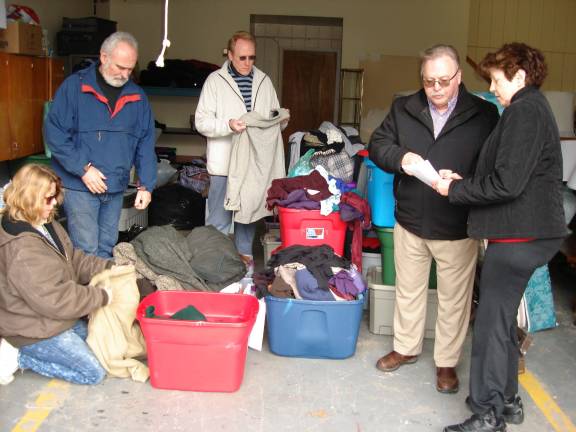 Midnight Run volunteers mourn 'incredible' Lori Baird Volunteers (from left) Pam Pylant, John Redmond, and Brad McLeland look over donated clothing and blankets for the next Midnight Run, while they Rev. Kingsley and Wendy Wade become familiar with the stops in New York City