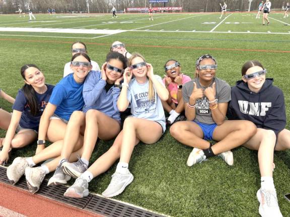 Faculty, staff, and several students took to the athletic fields to observe the celestial event.