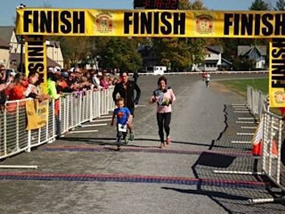 Runners rack up miles at first-ever marathon The Ansick family from Auburn, Alabama: William, Emily and son Miles cross the finish line. They’re visiting their aunt, Linda Hulse, who lives in Goshen. (Photo by Geri Corey)