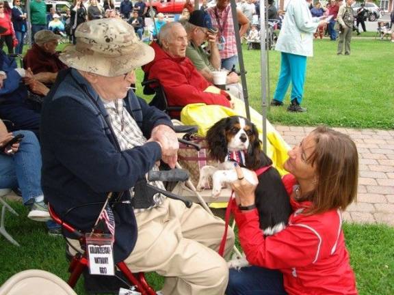 Goshen: 'Our duty to remember' Veteran Anthony Kolodziejsky is introduced to “Rigby,” a seven-month-old Cavalier King Charles Spaniel puppy. His owner, Kim Bachorik of Goshen, is happy to share him with others. (Photo by Geri Corey)