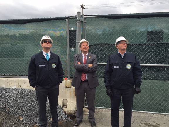 'Topping out' ceremony held at government center County Executive Steve Neuhaus, Commissioner of Public Works Chris Viebrock and Deputy County Executive Wayne Booth watch as the last steel beam is raised to the upper floor in the new Division Two (Photo provided)