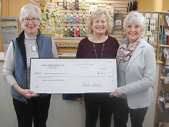 Linda Mabie, owner of Linda’s Office Supplies and Gifts, on the left, is happy to donate a check for $600 to Yvonne Mirro, center, and Mary Troy. Mirro is president of the Friends of the Goshen Library and Troy is vice-president of the Friends of the Goshen Library. The check is a portion of the proceeds from the sale of an ornament representing the new library; the latest in a series of seven ornaments.