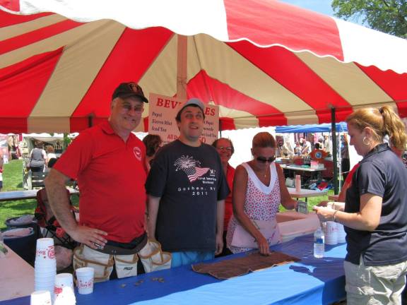 Scenes from Great American Weekend Quenching thirsts at the Orange County Chamber of Commerce tent (from left): Tom, Jimmy and Mary Rodhe (peeking from behind, in red shirt) and another crew member dispense cold drinks.