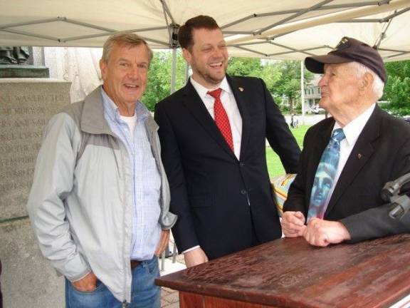 Goshen: 'Our duty to remember' Guest speaker Patrick Davis (center) shares a light moment with Al Stipak, 94-year-old veteran of World War II. With them is Town of Goshen Councilman Ken Newbold. Stipak, who lived in Newburgh for years, is now a Goshenite. “I love it,” he says. “It’s a beautiful town." (Photo by Geri Corey)